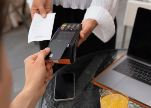 Man making a contactless payment by tapping card on a payment machine